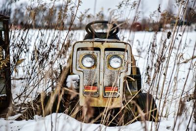 Abandoned tractor on snow covered field