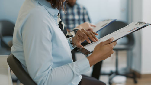 Midsection of man using laptop