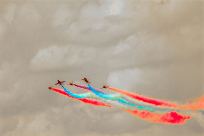 Low angle view of airshow against sky