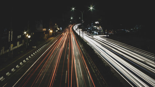 High angle view of light trails on road at night