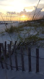 Scenic view of frozen lake against sky during sunset