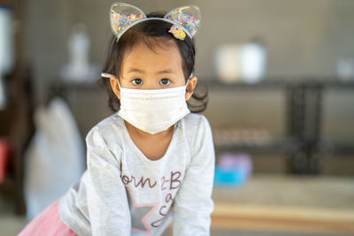 Little girl wearing mask prevent pollution outdoor.