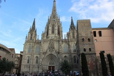 Low angle view of barcelona cathedral against sky