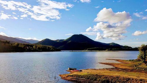 Scenic view of lake and mountains against sky