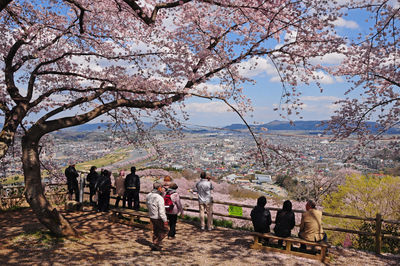 High angle view of people standing by railing looking at cityscape