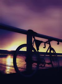 Silhouette bicycle against sky during sunset