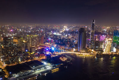 High angle view of illuminated buildings against sky at night