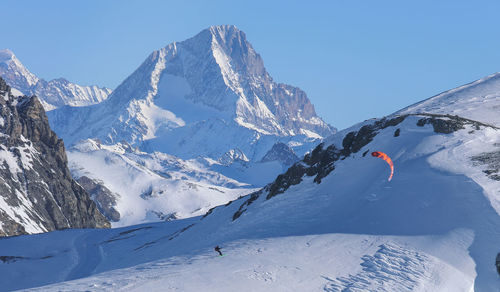 Scenic view of snow covered mountains against sky