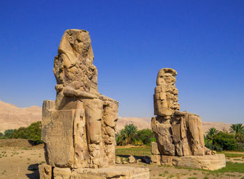 View of rock formation against clear blue sky