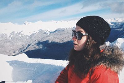 Woman wearing warm clothing on mountain during winter