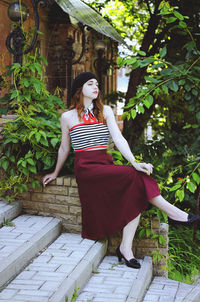 Portrait. young, happy, elegant redhead curly woman, girl in hat, casual clothes. french style. city