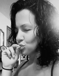 Close-up portrait of young woman with eyes closed