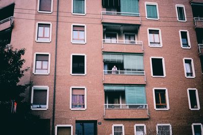 Low angle view of man standing in balcony