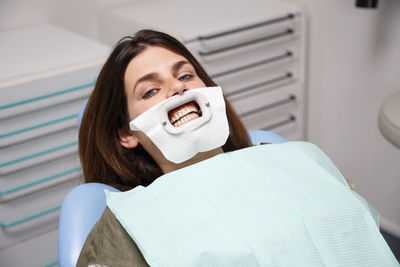 Portrait of woman with dental equipment in clinic