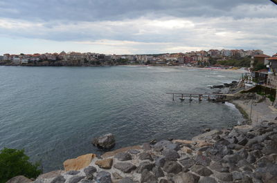 View of cityscape against cloudy sky