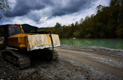 Abandoned vehicle on land against sky