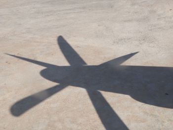 High angle view of silhouette airplane on sunny day