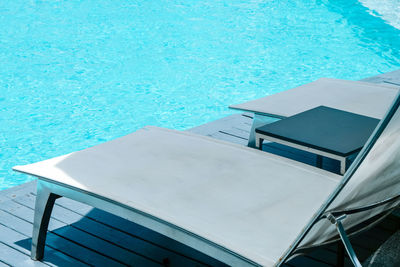 High angle view of lounge chairs at poolside