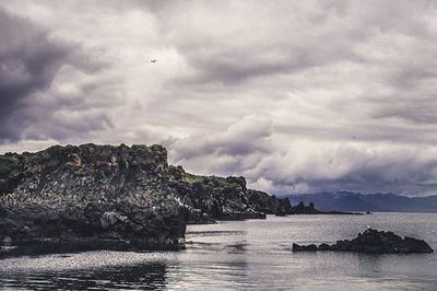 Scenic view of sea against cloudy sky
