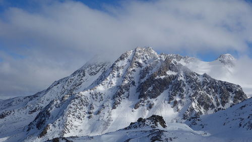 Low angle view of snowcapped mountain against sky