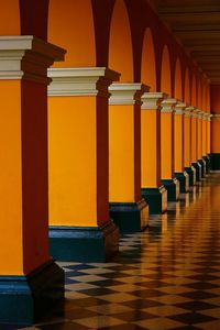 Empty corridor along pillars in row