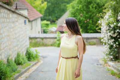 Lifestyle portrait of young stylish woman with long brunette hair