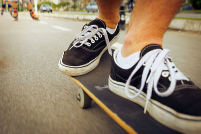 Low section of man riding skateboard