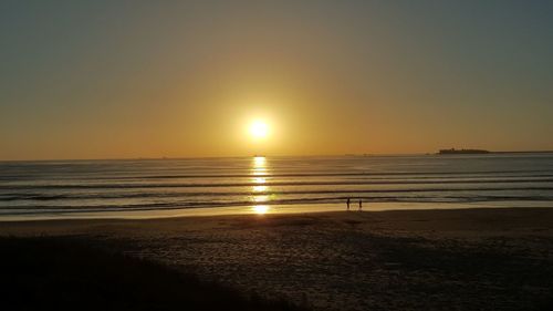 Scenic view of sea against clear sky during sunset