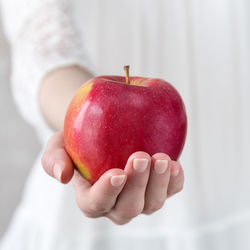 Close-up of hand holding apple