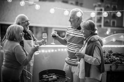 Happy senior couples toasting wine