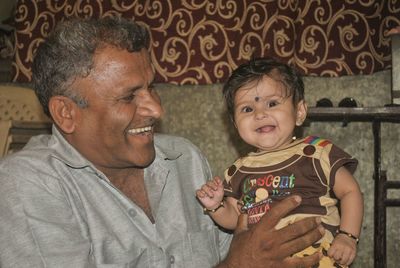 Portrait of cute girl with father at home