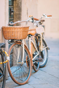 Bicycle parked on street against wall