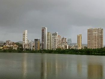 River by buildings against sky in city