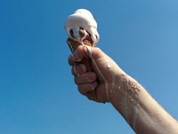 Hand holding ice cream cone