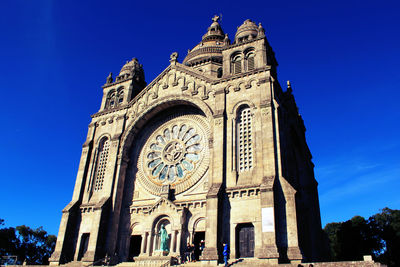 Low angle view of church against blue sky