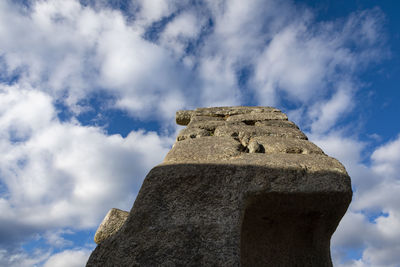 Low angle view of old ruin building against cloudy sky