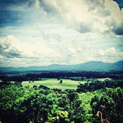 Scenic view of mountains against cloudy sky