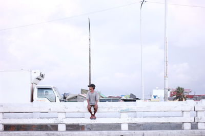 Full length of woman standing by railing