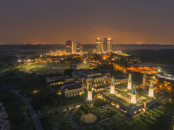 High angle view of illuminated buildings in city at night
