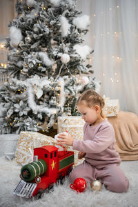 Cute girl decorating christmas tree