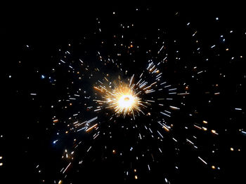 Low angle view of firework display at night