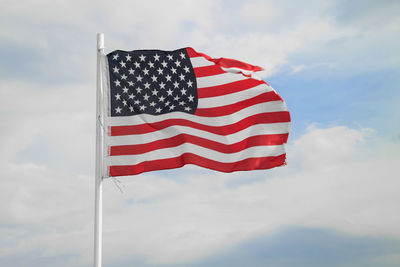 Low angle view of flag against sky