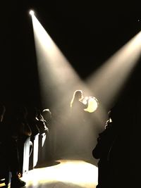 Close-up of lit candle at night