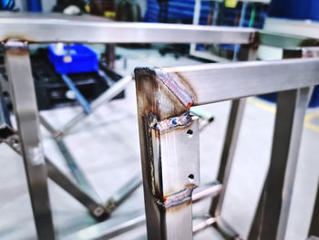 High angle view of metallic railing against blue sky