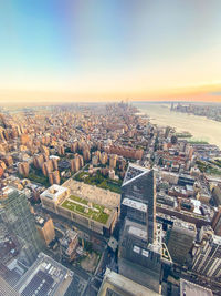 High angle view of city buildings against sky during sunset