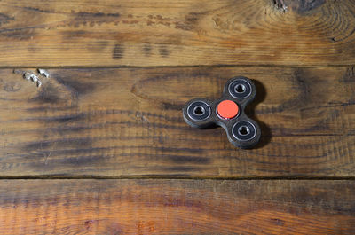 Close-up of fidget spinner on wooden table