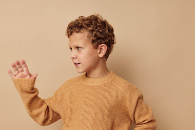 Side view of young man against white background