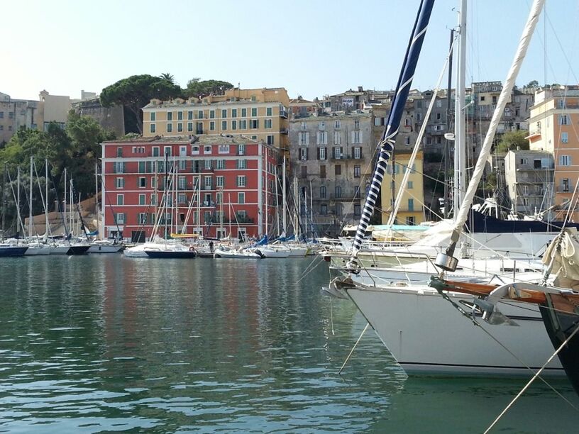 nautical vessel, moored, transportation, boat, mode of transport, water, building exterior, architecture, built structure, waterfront, harbor, mast, sailboat, clear sky, river, reflection, sky, city, day, outdoors