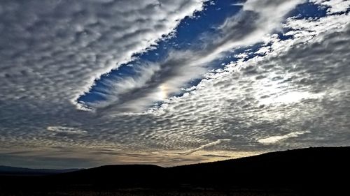 Low angle view of silhouette mountain against sky during sunset