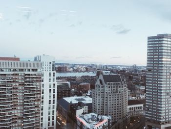 Buildings in city against sky during winter